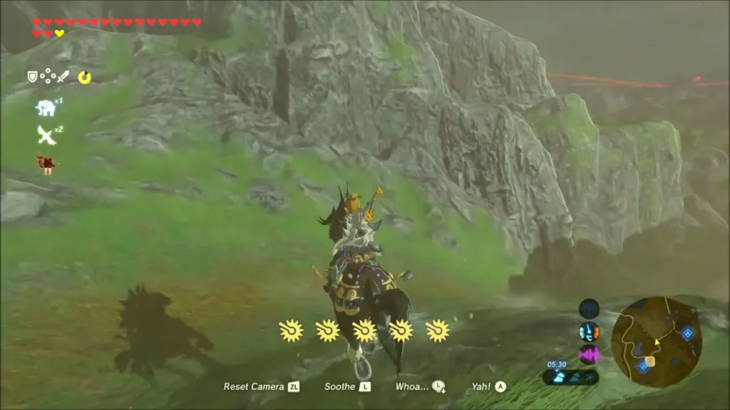 Link riding his horse along a rocky hillside toward the lake Link riding his horse along a rocky hillside toward the lake