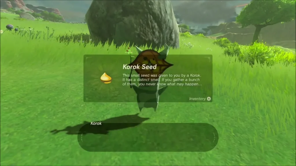 A Korok giving a seed behind a boulder in the grass A Korok giving a seed behind a boulder in the grass