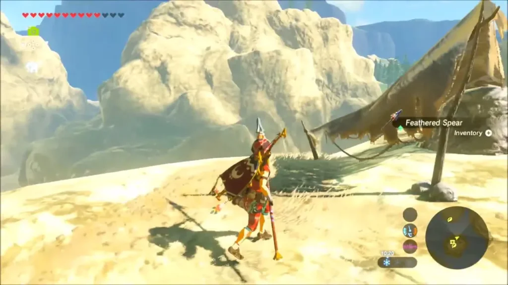 Link holding the Feathered Spear beside a tattered tent on a rocky ledge Link holding the Feathered Spear beside a tattered tent on a rocky ledge