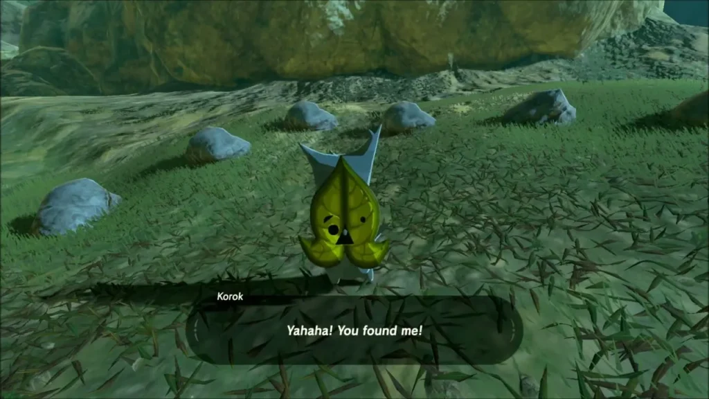 Korok in the grass beside a boulder saying Yahaha, you found me Korok in the grass beside a boulder saying Yahaha, you found me