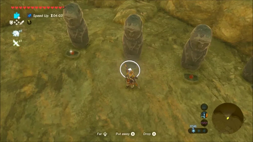 Link holding an apple in front of three tall stone statues Link holding an apple in front of three tall stone statues