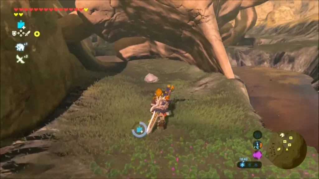 Link standing on grass beneath a rock and bone arch Link standing on grass beneath a rock and bone arch