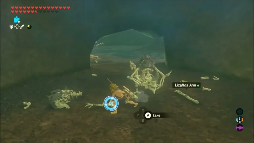 Link picking up a Lizalfos Arm from a fallen skeleton monster in a cave Link picking up a Lizalfos Arm from a fallen skeleton monster in a cave