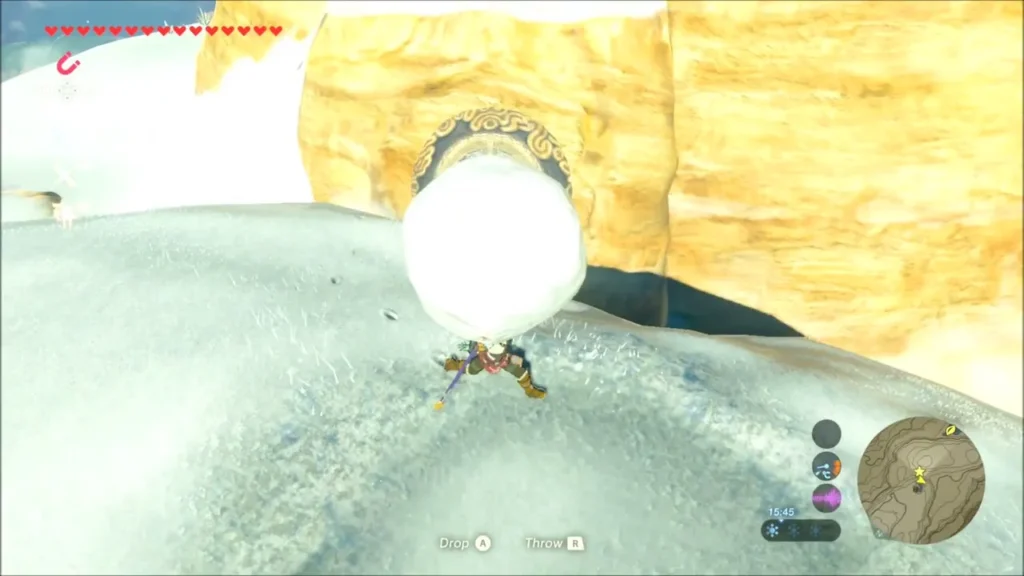 Link carrying a large snowball beneath the round carving in the rock Link carrying a large snowball beneath the round carving in the rock