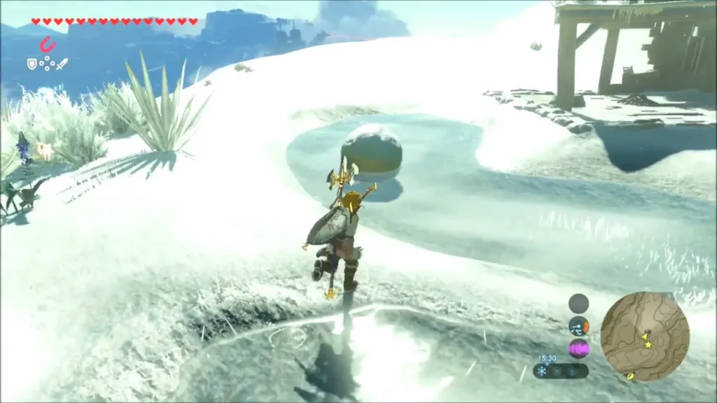 Link rolling a snowball across snowy ground below a cliff Link rolling a snowball across snowy ground below a cliff