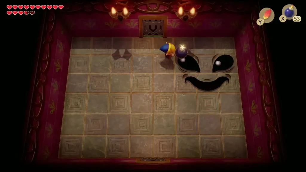 Link throwing a bomb at Facade's face from the wall Link throwing a bomb at Facade's face from the wall