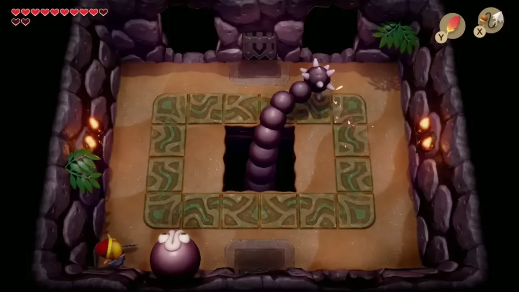 Link beside a decoy head in the Slime Eel arena while the tail sweeps the ring Link beside a decoy head in the Slime Eel arena while the tail sweeps the ring