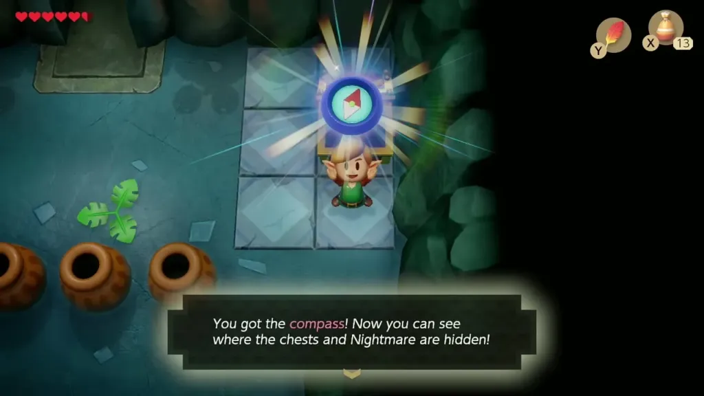 Link holding up the Compass with its message box in Bottle Grotto