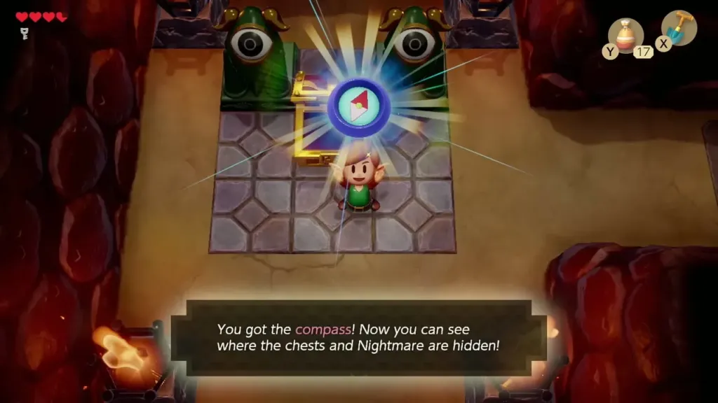 Link holding up the Compass with its message box in Tail Cave