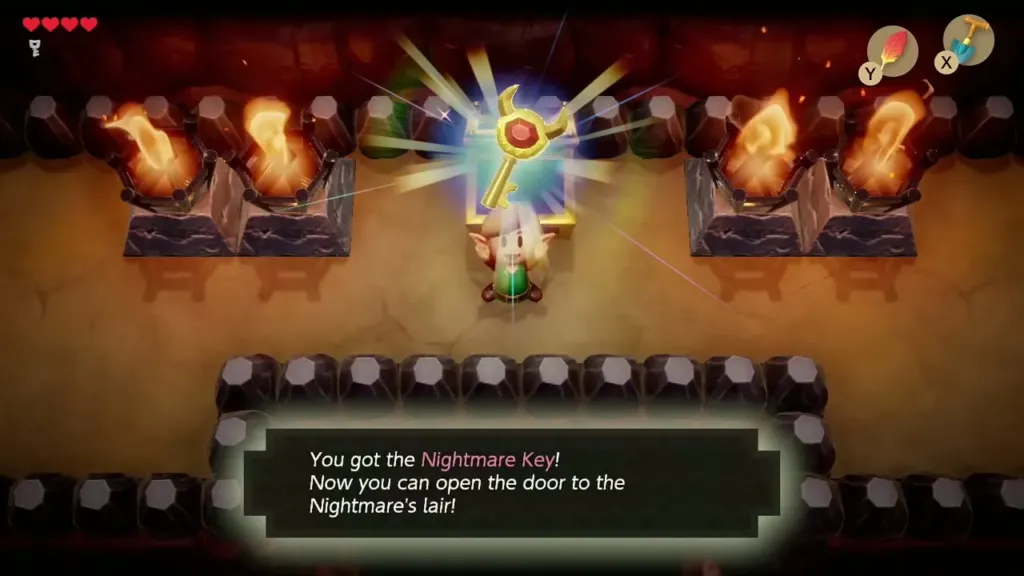 Link holding up the Nightmare Key with its message box in Tail Cave