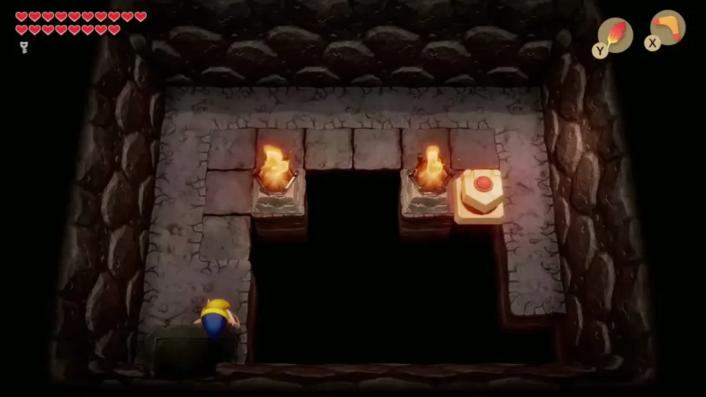 Red-button block being pushed to fill the floor gap between two lit torches