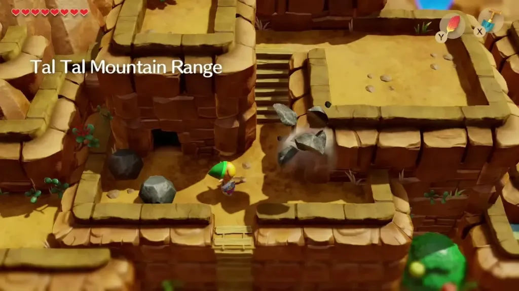 Link on a Tal Tal Mountain Range ledge as rocks tumble down toward him Link on a Tal Tal Mountain Range ledge as rocks tumble down toward him