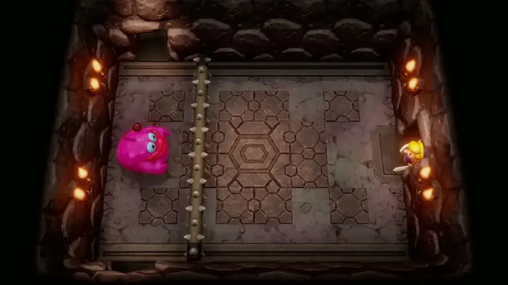 Link across a spiked bar from a large pink blob in Turtle Rock Link across a spiked bar from a large pink blob in Turtle Rock