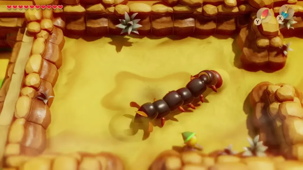 A giant sand centipede in the Yarna Desert while Link waits at the edge A giant sand centipede in the Yarna Desert while Link waits at the edge