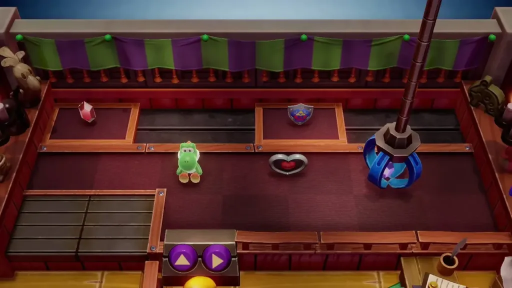 The crane claw dropped and closing on a prize with the control buttons below The crane claw dropped and closing on a prize with the control buttons below