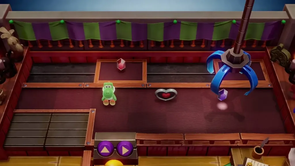 The crane claw steered toward a purple rupee at the right of the prize floor The crane claw steered toward a purple rupee at the right of the prize floor