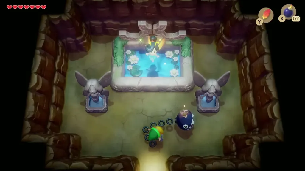 Link and BowWow in the fountain room with the pool between two winged statues Link and BowWow in the fountain room with the pool between two winged statues