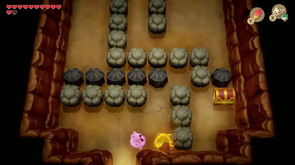 Cave room with black barriers and rocks blocking the way to a chest