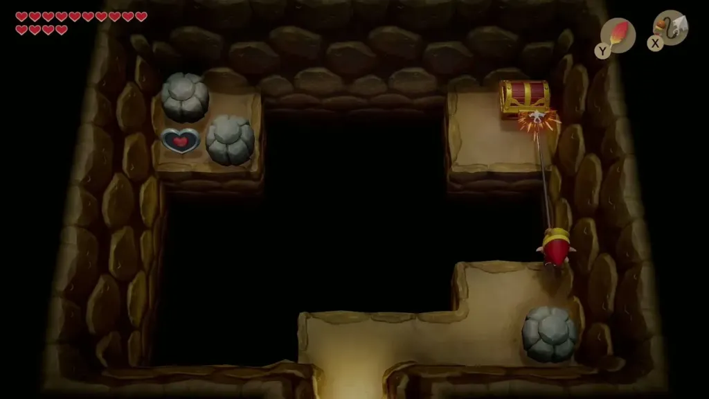 Link Hookshotting across the gap to the chest in the cave