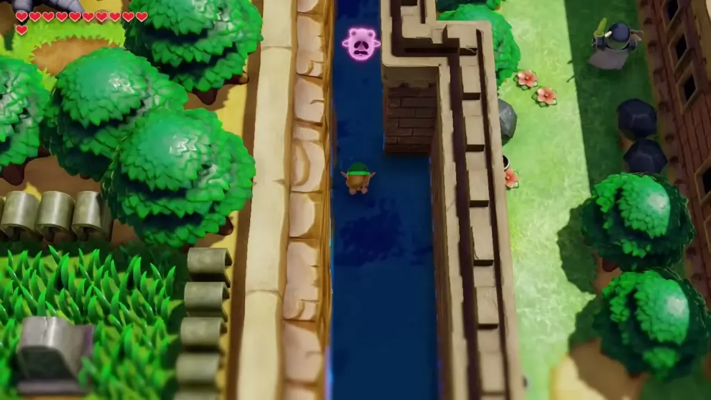 Link swimming down the narrow stream beside the castle wall