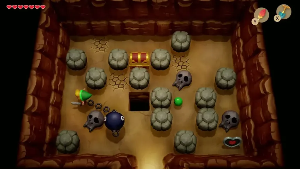 Cave room of rocks and skulls with a chest and a heart piece in the corner