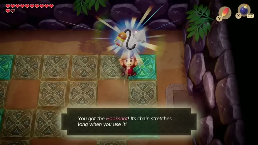 Link holding up the Hookshot with its name box in Catfish's Maw Link holding up the Hookshot with its name box in Catfish's Maw