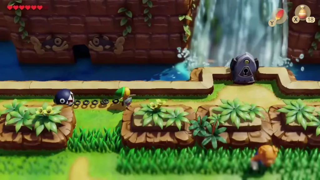 Link and BowWow beside a waterfall and a locked stone owl on the Tal Tal ledge Link and BowWow beside a waterfall and a locked stone owl on the Tal Tal ledge