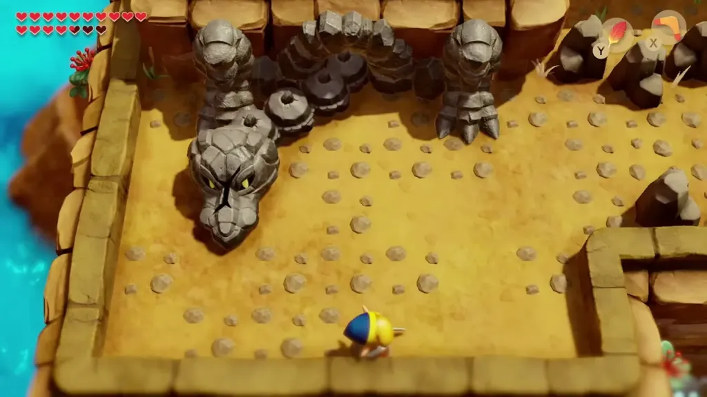 The stone serpent head charging across the sand toward Link The stone serpent head charging across the sand toward Link