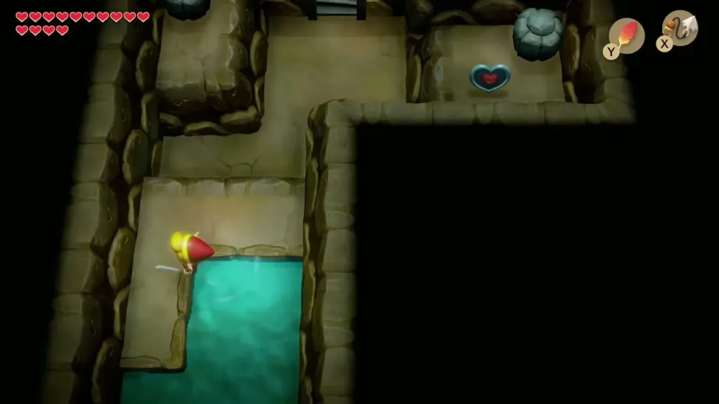 Link beside a pool in the cave with a Piece of Heart on a far ledge Link beside a pool in the cave with a Piece of Heart on a far ledge