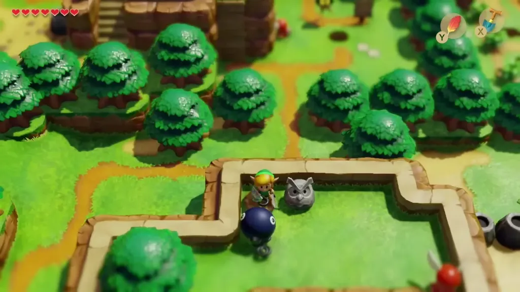 Link standing beside the Owl Statue outside the cave Link standing beside the Owl Statue outside the cave