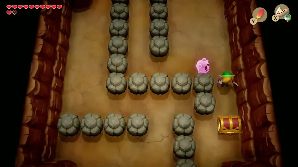 Link working past stones toward the red chest in the cave Link working past stones toward the red chest in the cave