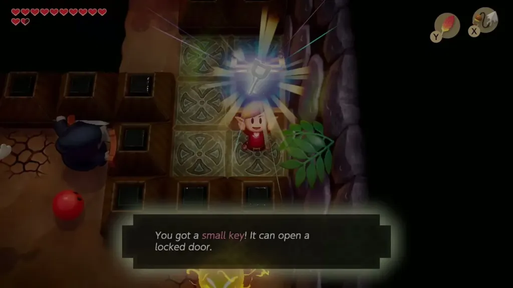 Link holds up another small key with the message that it can open a locked door Link holds up another small key with the message that it can open a locked door