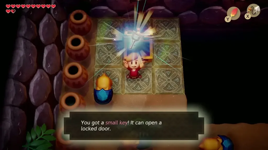 Link holds up a small key with its name box Link holds up a small key with its name box
