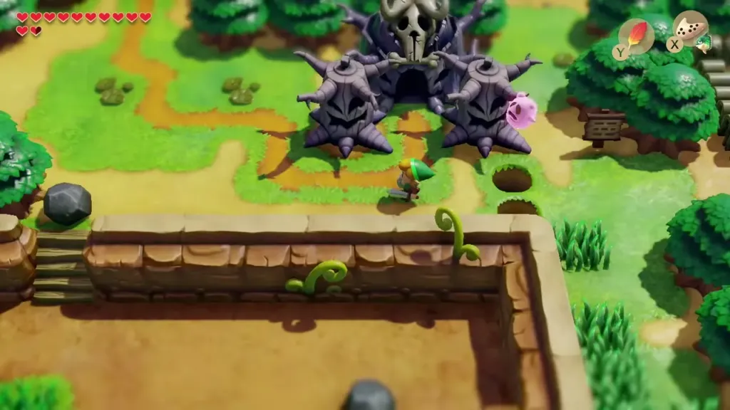 Link walking past the skull-topped spiked trees at the Cemetery edge with the pink Ghost floating beside him Link walking past the skull-topped spiked trees at the Cemetery edge with the pink Ghost floating beside him