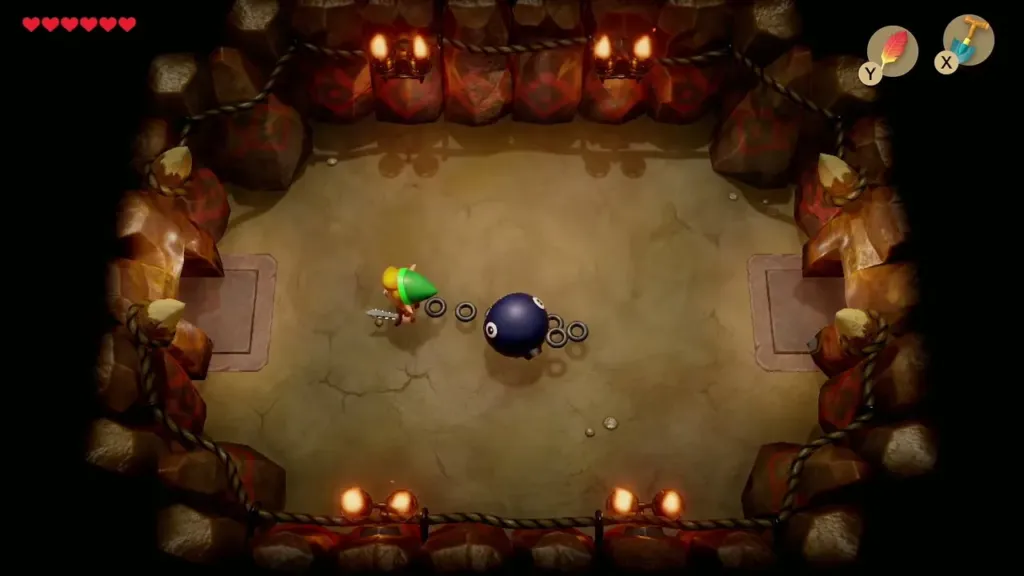 Link leading BowWow on his chain through the cave room Link leading BowWow on his chain through the cave room