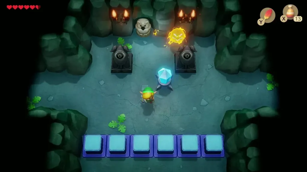 Link facing the blue crystal switch with raised blue blocks below Link facing the blue crystal switch with raised blue blocks below