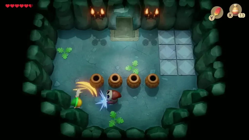 Link striking a Mask-Mimic with his Sword in the compass room Link striking a Mask-Mimic with his Sword in the compass room