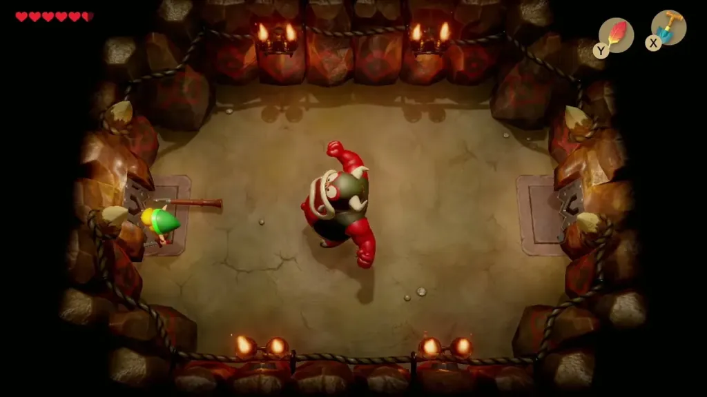The Moblin Chief with raised arms in the third room while Link guards The Moblin Chief with raised arms in the third room while Link guards