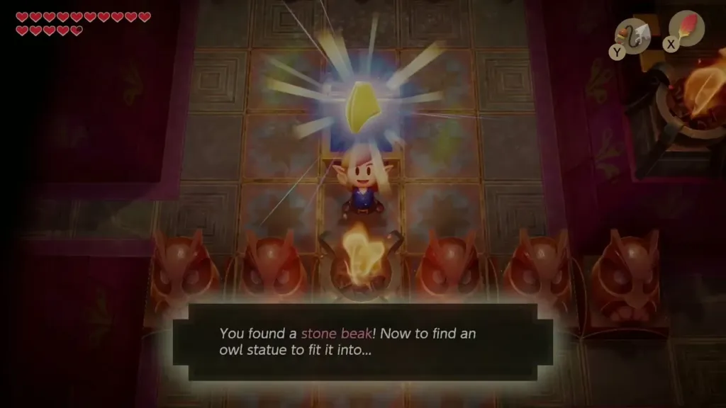 Link holding up the Stone Beak in front of owl statues Link holding up the Stone Beak in front of owl statues
