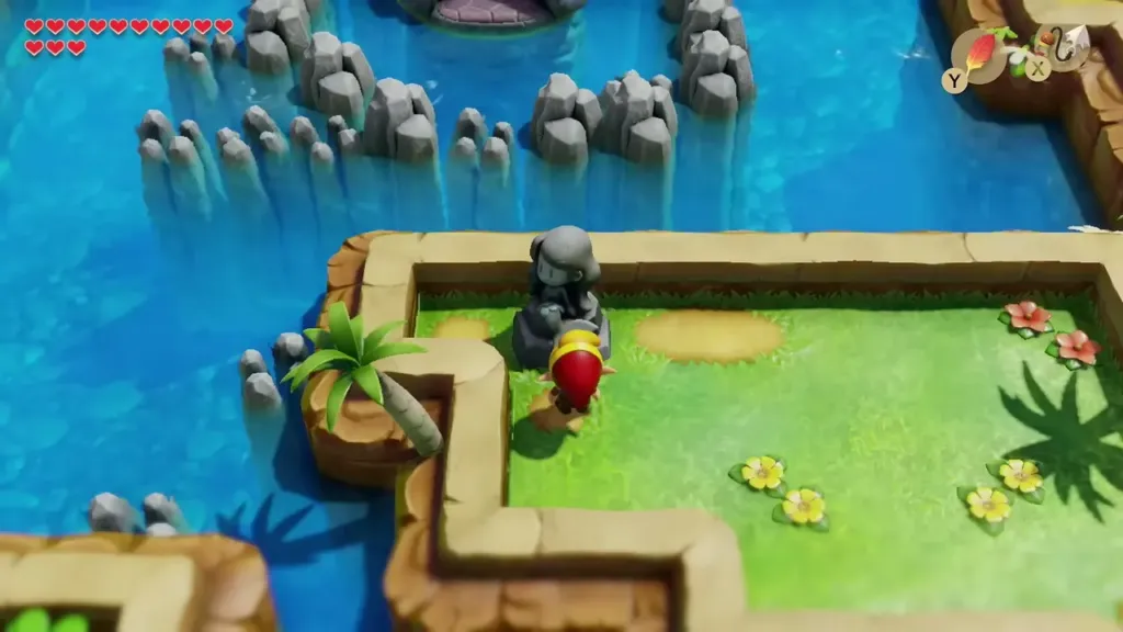 Link standing at the Mourning Mermaid statue on its grassy ledge Link standing at the Mourning Mermaid statue on its grassy ledge