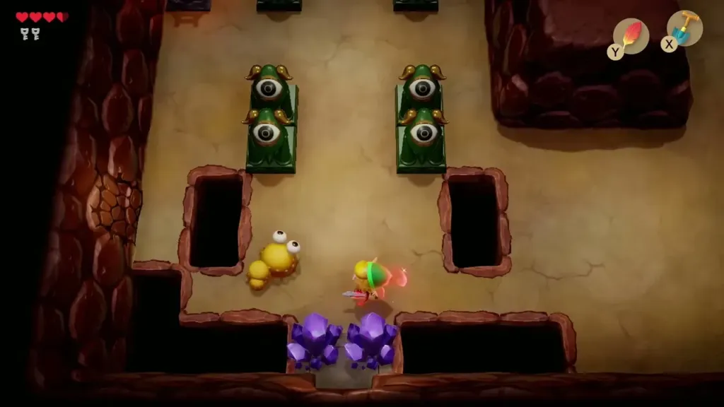 Link fighting Mini-Moldorms in a Tail Cave room with pits Link fighting Mini-Moldorms in a Tail Cave room with pits