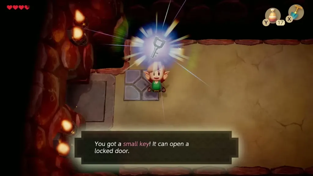 Link holding up a Small Key with its message box in the Tail Cave Link holding up a Small Key with its message box in the Tail Cave
