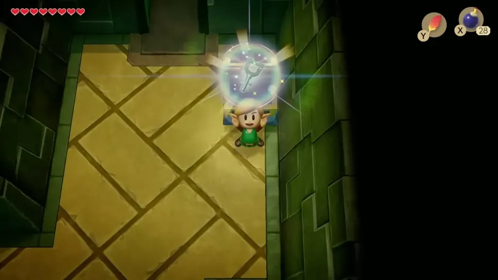 Link holding up the first Small Key beside the opened chest in Key Cavern