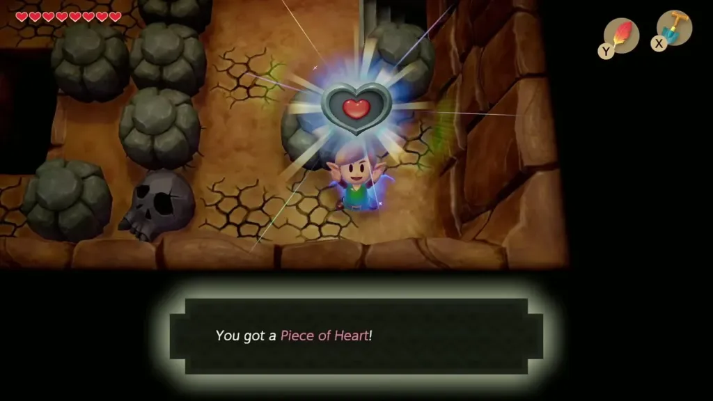 Link holding up a Piece of Heart in the mountain cave with the item message shown