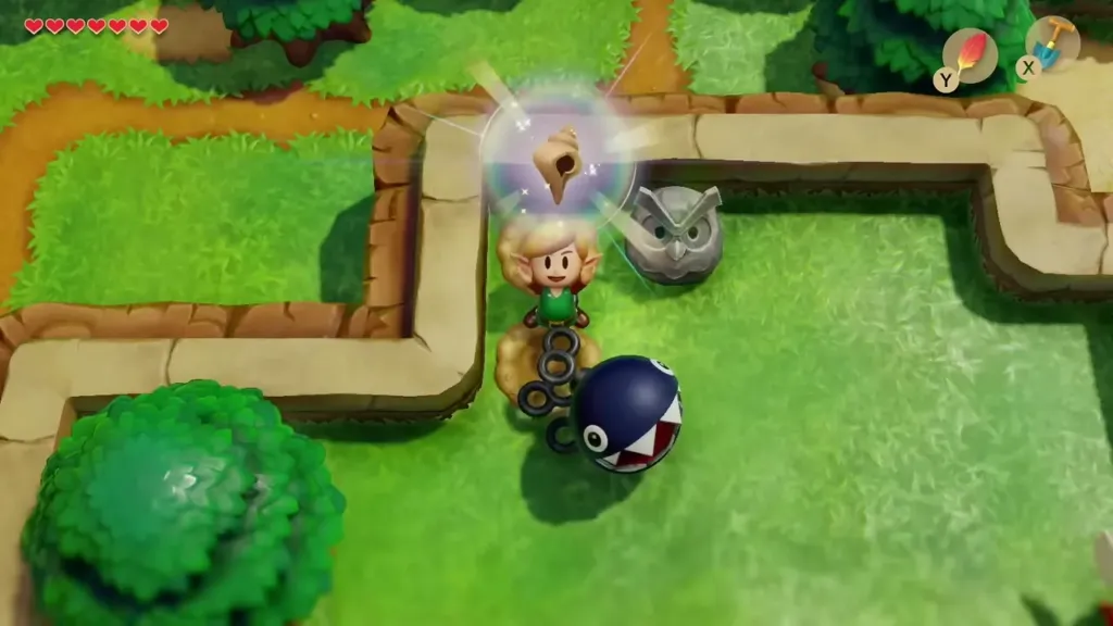 Link holding up a Secret Seashell dug up next to the Owl Statue