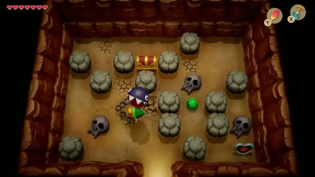 Cave room full of rocks and skulls with a chest and a heart piece