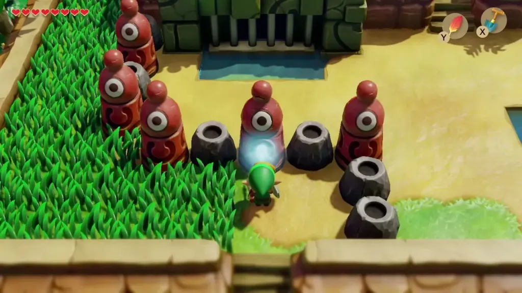 Link using the Slime Key on the red statue before the barred gate