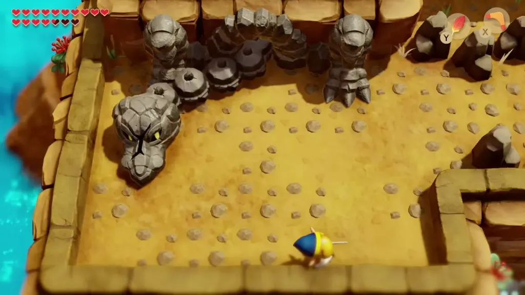 A stone serpent head sliding across the sand arena while Link keeps his distance A stone serpent head sliding across the sand arena while Link keeps his distance