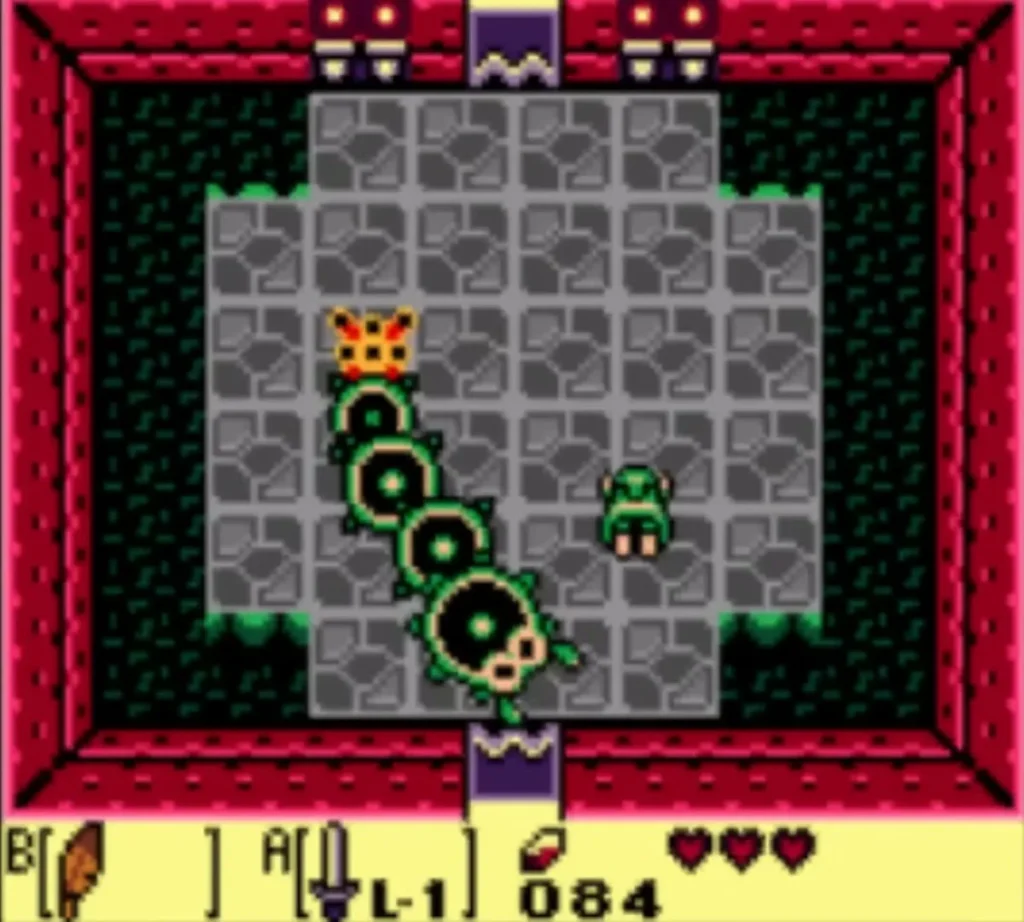 Moldorm with its orange head stretches across the Tail Cave arena while Link stands at the lower right