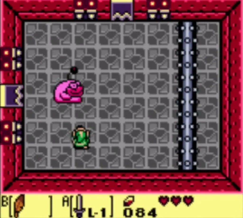 Pink Rolling Bones beside a vertical spiked bar along the wall of a stone room